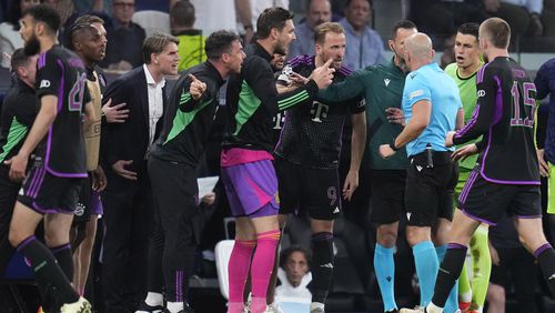 Bayern Munich players argues with referee Szymon Marciniak at the end of the Champions League semifinal second leg soccer match between Real Madrid and Bayern Munich at the Santiago Bernabeu stadium in Madrid, Spain, Wednesday, May 8, 2024. (AP Photo/Manu Fernandez)