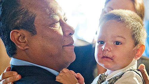 July 2, 2014 Atlanta - Bounkham Phonesavanh Sr. (left) holds his son Bounkham during a farewell breakfast at Delightful Eatz in Atlanta on Wednesday, July 2, 2014. Known as Baby Bou Bou, the young child has been in the hosital for the past five weeks after a botched drug raid in Habersham County. JONATHAN PHILLIPS / SPECIAL