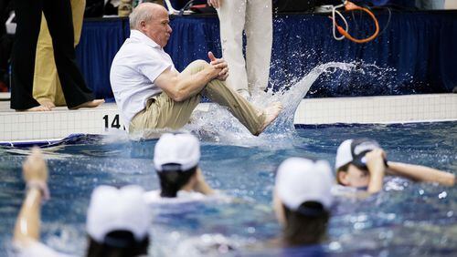 Georgia coach Jack Bauerle jumps into the water as the team celebrates after winning the NCAA women's swimming and diving championships in March 2016 in Atlanta. (AP Photo/David Goldman)