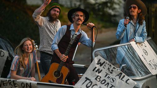 Taking it to the streets through Ormewood Park, are members of the Mermaid Motor Lounge band (Left to right: Jenna Mobley, Troy Harris (flashing the peace sign), Josh Erwin and Matt Pendrick. (Photo credit: Brian Thorpe)