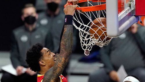 Atlanta Hawks forward John Collins dunks during the first half of an NBA basketball game against the Los Angeles Clippers Monday, March 22, 2021, in Los Angeles. (AP Photo/Mark J. Terrill)