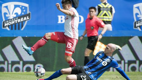 Montreal Impact’s Laurent Ciman, right, challenges Atlanta United’s Hector Villalba during first half of an MLS soccer game in Montreal, Saturday, April 15, 2017. (Graham Hughes/The Canadian Press via AP)