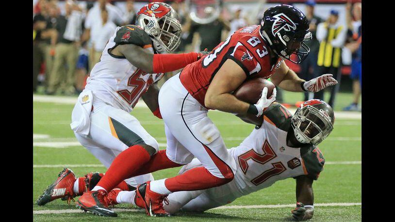 Falcons tight end Jacob Tamme knocks Buccaneers cornerback Alterraun Verner to the ground on his way into the endzone for a touchdown to cut the Buccaneers lead to 20-10 during the third quarter in a football game on Sunday, Nov. 1, 2015, in Atlanta. The Falcons fall 23-20 to the Buccaneers in over time. (Photo by Curtis Compton)
