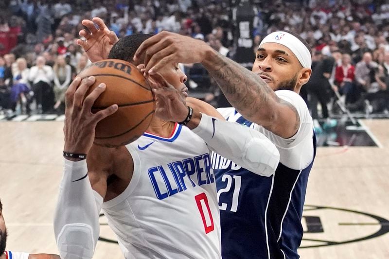 Los Angeles Clippers guard Russell Westbrook, left, grabs a rebound as Dallas Mavericks center Daniel Gafford reaches for it during the first half in Game 5 of an NBA basketball first-round playoff series Wednesday, May 1, 2024, in Los Angeles. (AP Photo/Mark J. Terrill)