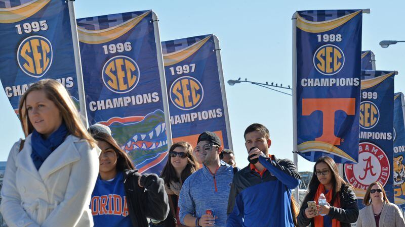 SEC Champion banners are shown outside the Georgia Dome as fans arrive for the 2015 SEC Championship between Alabama Crimson Tide and Florida Gators on Saturday Dec. 5, 2015.