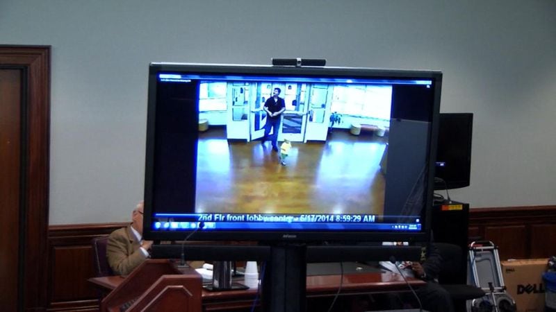 In this video from the Little Apron Academy, Justin Ross Harris is shown dropping off Cooper the day before Cooper's death. Cooper is wide awake on this day. The video is being shown to the jury during Harris' murder trial at the Glynn County Courthouse in Brunswick, Ga., on Friday, Oct. 21, 2016. (screen capture via WSB-TV)