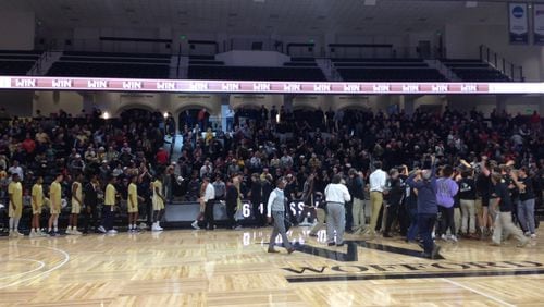Wofford students celebrate on the court after the Terriers upset Georgia Tech 63-60 Wednesday night in Spartanburg, S.C.