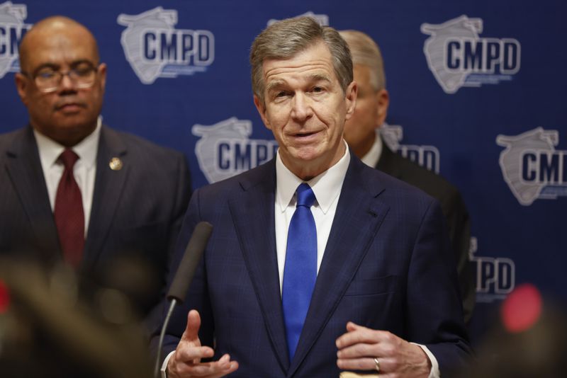 North Carolina Governor Roy Cooper speaks at a press conference in Charlotte, N.C., Tuesday, April 30, 2024, regarding the shooting that killed several officers and wounded others during an attempt to serve a warrant on Monday. (AP Photo/Nell Redmond)