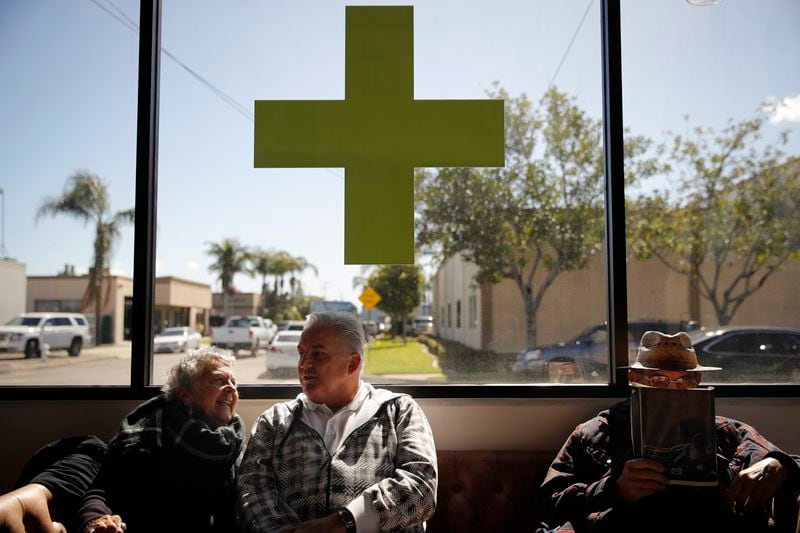 FILE - Kay Nelson, left, and Bryan Grode, retried seniors from Laguna Woods Village, chat in the lobby of Bud and Bloom cannabis dispensary while waiting for a free shuttle to arrive in Santa Ana, Calif., Feb. 19, 2019. Marijuana advocates are gearing up for Saturday, April 20, 2024. Known as 4/20, marijuana's high holiday is marked by large crowds gathering in parks, at festivals and on college campuses to smoke together. Medical marijuana is now legal in 38 states. (AP Photo/Jae C. Hong, File)