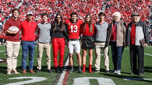 Georgia quarterback Stetson Bennett (13) poses with his family during the Senior Day ceremony before the Bulldogs’ game against Charleston Southern on Dooley Field at Sanford Stadium in Athens on Saturday, Nov. 20, 2021. His younger brother Luke, third from right, will walkon with the Bulldogs this season. (Photo by Tony Walsh/UGAAA)