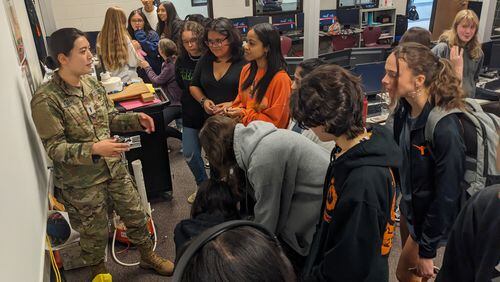 Space Force Captain Avery Evans, a 2015 Lanier High grad, speaks with the school's STEMGirls group during a recent visit.