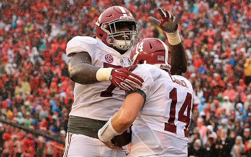 Alabama linebacker Cam Robinson celebrates with quarterback Jake Coker after he ran for a touchdown against Georgia for a 38-3 lead in their football game on Saturday, Oct. 3, 2015, in Athens. (Curtis Compton / ccompton@ajc.com)