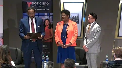 Atlanta mayoral candidates (left to right) Andre Dickens, Felicia Moore and Antonio Brown read a proclamation in recognition of Hispanic Heritage Month during a candidate forum on Tuesday, October 5 2021.