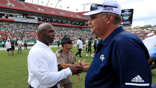 TAMPA, FL - SEPTEMBER 08:  Head coach Charlie Strong of the South Florida Bulls  and head coach Paul Johnson of the Georgia Tech Yellow Jackets  shake hands following a game  at Raymond James Stadium on September 8, 2018 in Tampa, Florida.  (Photo by Mike Ehrmann/Getty Images)