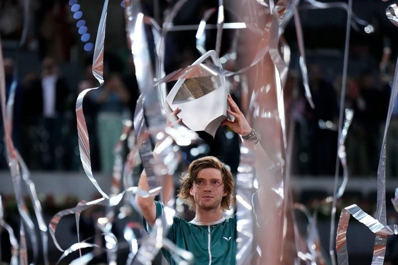 Andrey Rublev, of Russia holds his trophy after winning against Felix Auger-Aliassime, of Canada, in the Madrid Open men's final match in Madrid, Spain, Sunday, May 5, 2024. (AP Photo/Manu Fernandez)