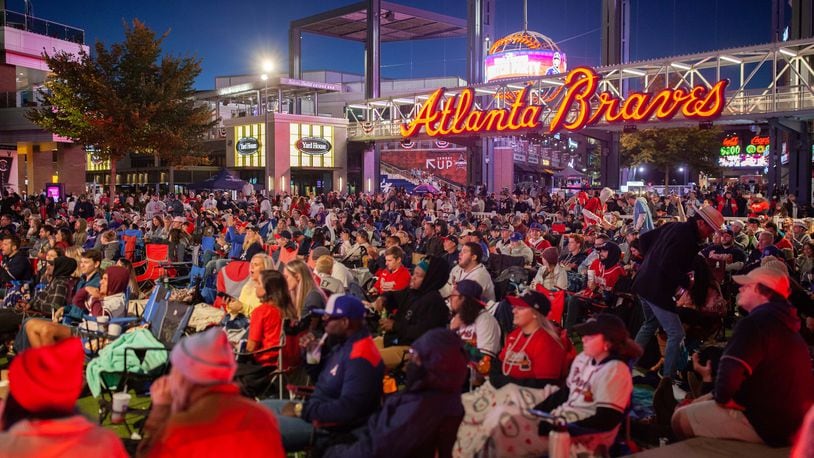 Fans gather at The Battery Atlanta on Tuesday to watch the first game of the World Series between the Braves and Astros on a video board. Games 1 and 2 were played in Houston. (Photo: Branden Camp for The Atlanta Journal-Constitution)
