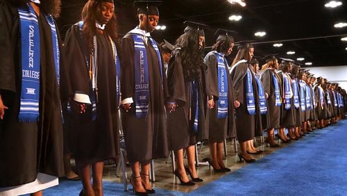 May 21, 2017, College Park: Graduates join hands for an opening prayer during the Spelman College 2017 Commencement Ceremony at the Georgia International Convention Center on Sunday, May 21, 2017, in College Park.     Curtis Compton/ccompton@ajc.com