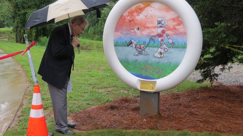 Peachtree Corners recently unveiled the first of six round shaped Button Art sculptures. The first sculpture features a friendly looking robot walking a robotic dog, a nod to the high-tech businesses in Technology Park. (Courtesy City of Peachtree Corners)