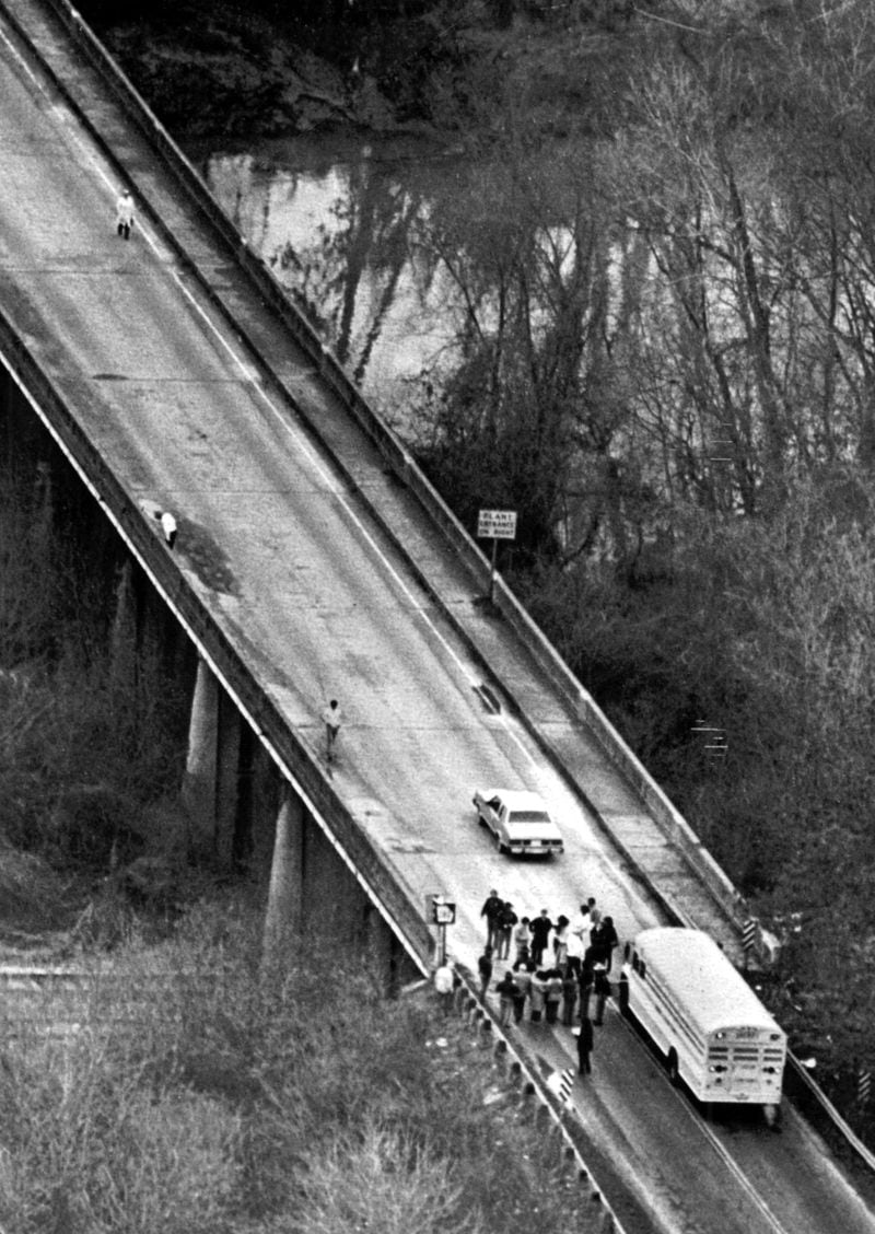 Jurors in the Wayne B. Williams trial leave the bus to walk onto the Jackson Parkway Bridge on Feb. 13, 1982, to personally examine the site where prosecutors in the trial charged that Williams dumped his victims into the Chattahoochee River. (UPI-David Tulis-1982)