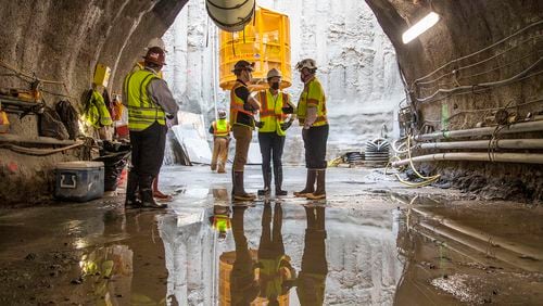 U.S. Secretary of Transportation Pete Buttigieg, center, receives a tour of an underground tunnel at Hartsfield–Jackson International Airport during a visit in May. (Alyssa Pointer / Alyssa.Pointer@ajc.com)