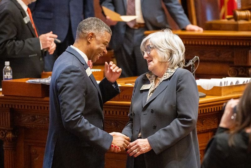 Rep. James Beverly, D-Macon, is greeted by Rep. Debbie Buckner, D-Junction City, following his farewell speech at the Capitol in Atlanta on Tuesday.