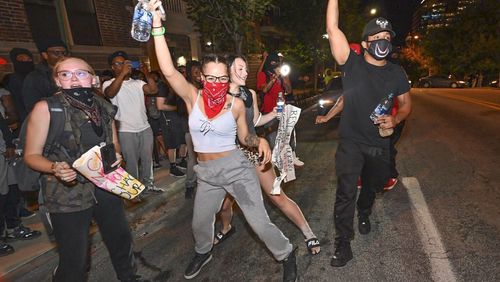Small groups of people roamed the streets  after curfew Saturday, some vandalizing property, as protests began for a second day.  Protests over the death of George Floyd in Minneapolis police custody spread around the United States on Saturday, as his case renewed anger about others involving African Americans, police and race relations.