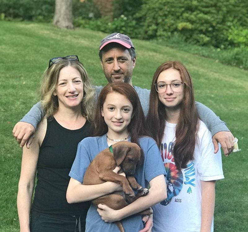 The Cohen family, clockwise from left: Dena, Mark, Grey and Sidney Cohen with their puppy Olive. COURTESY OF THE COHEN FAMILY