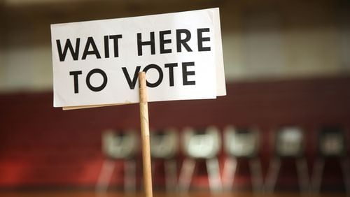 A "Wait here to vote," sign at Midtown High School in Atlanta (JASON GETZ/AJC)
