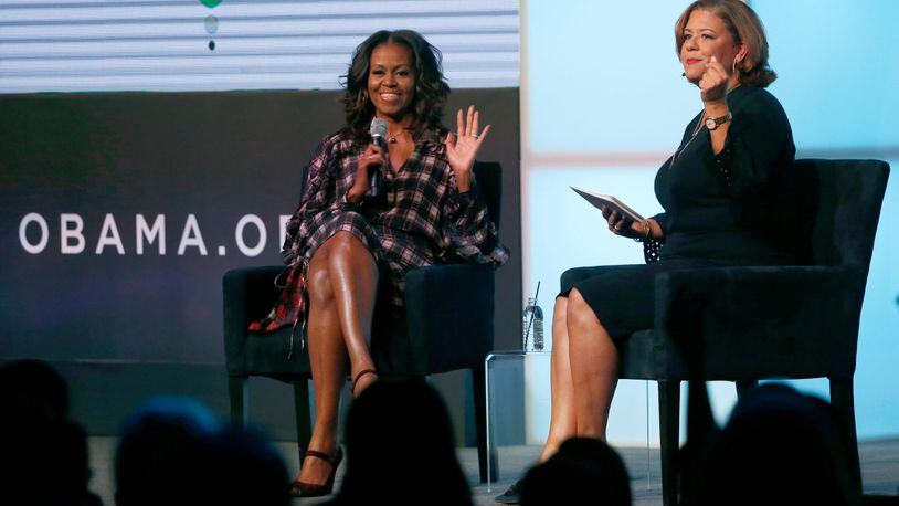 Former first lady Michelle Obama, left, responds to a statement by poet Elizabeth Alexander during a conversation about youth empowerment and dedicating oneself to a life of public service during the second day of the Obama Foundation Summit Wednesday, Nov. 1, 2017, in Chicago. (AP Photo/Charles Rex Arbogast)