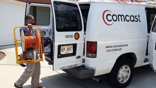 In this file photo, Comcast technician Elston Nesbitt installs service in a home in Forsyth County. AJC File Photo