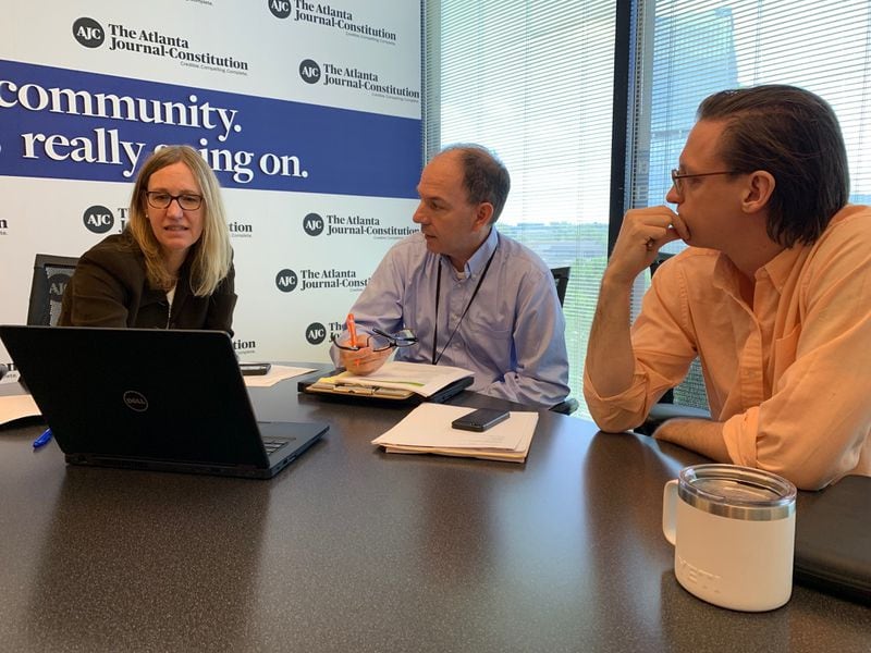 AJC investigative reporters Carrie Teegardin (left), Brad Schrade and data specialist Nick Thieme discuss the "Unprotected" project in this 2019 photo.