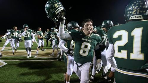 November 7, 2014 - Roswell, Ga: Blessed Trinity fullback Jake Bogosian (8) celebrates with teammates after their win over Cedar Grove Friday November 7, 2014, in Roswell, Ga.. Blessed Trinity won 28-21 to win the region championship. JASON GETZ / SPECIAL