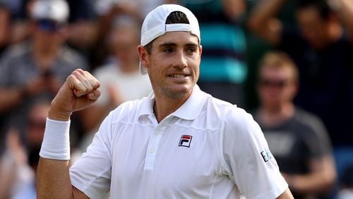 John Isner, a former star at Georgia, celebrates winning his men's singles fourth round against Stefanos Tsitsipas of Greece on day seven of the Wimbledon Lawn Tennis Championships at All England Lawn Tennis and Croquet Club on July 9, 2018 in London.