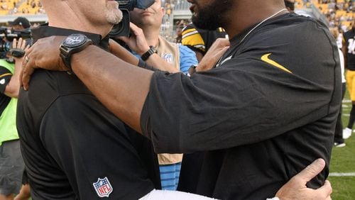 Atlanta Falcons head coach Dan Quinn, left, and Pittsburgh Steelers head coach Mike Tomlin embrace after an NFL preseason football game, Sunday, Aug. 20, 2017, in Pittsburgh. The Steelers won 17-13. (AP Photo/Don Wright)