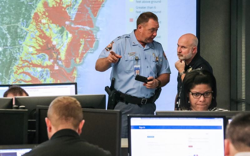At the Georgia Emergency Management Agency operation center Thursday morning, Georgia State Patrol Capt. Ryan Newman (left) and Director of Juvenile Justice Scott Cagle discuss the state's response to Hurricane Matthew. JOHN SPINK / JSPINK@AJC.COM