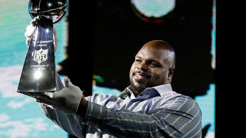 Vince Wilfork holds the Vince Lombardi Trophy as he helps with delivery of the trophy at the NFL Experience in 2017 in Houston.