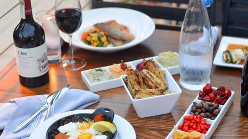 The tables at Mediterranea tend to fill quickly with shared plates and bottles of wine. CONTRIBUTED BY HENRI HOLLIS