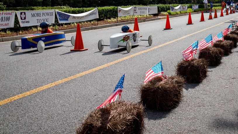Two cars head for the finish line during a soapbox derby. A proposal to designate the Southeast Georgia Soap Box Derby in Lyons as the state’s official soapbox derby for tourism purposes moved forward Thursday when the Georgia House voted unanimously for it. The measure now heads to the state Senate. STEVE SCHAEFER / SPECIAL TO THE AJC