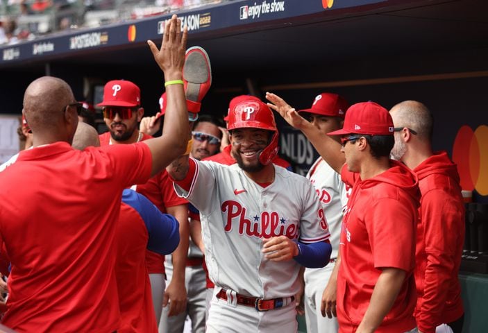 Philadelphia Phillies' Edmundo Sosa celebrates his score on an RBI by Nick Castellanos during the fourth inning of game one of the baseball playoff series between the Braves and the Phillies at Truist Park in Atlanta on Tuesday, October 11, 2022. (Jason Getz / Jason.Getz@ajc.com)