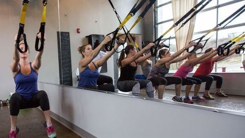 TRX, a form of strength training that uses a system of ropes and webbing, is popular among trainers.