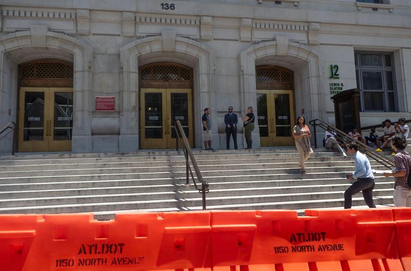 Small orange barricades surround around the Fulton County Courthouse on Monday in Atlanta, the first visible sign of increased security measures ahead of the possible indictment of former President Donald Trump.