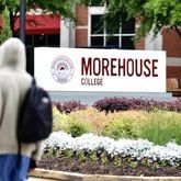 A student walks by a Morehouse College sign in Atlanta on April 24, 2024. (Miguel Martinez/AJC)