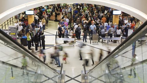 Crowds flow through Hartsfield-Jackson International Airport. Storage of surplus office furniture from the giant complex turned out to be costly. (AP Photo/David Goldman)