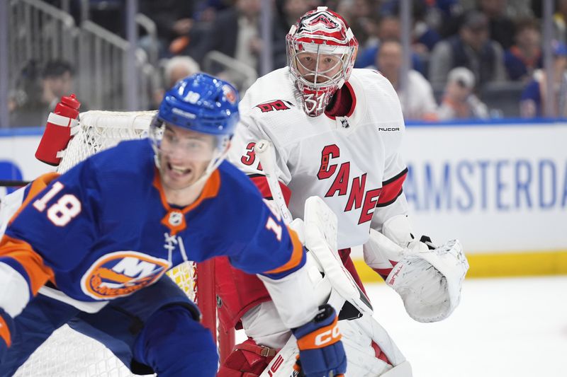 Carolina Hurricanes goaltender Frederik Andersen protects the net as New York Islanders' Pierre Engvall skates in front of him during the second period of Game 3 of an NHL hockey Stanley Cup first-round playoff series Thursday, April 25, 2024, in Elmont, N.Y. (AP Photo/Frank Franklin II)