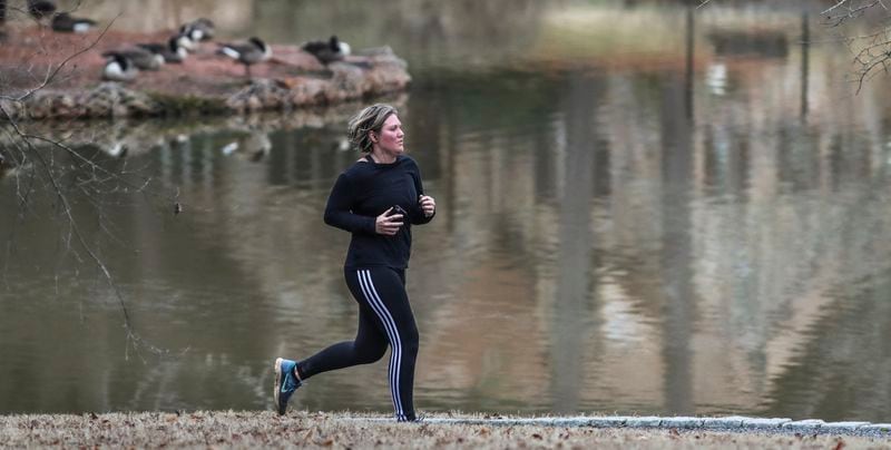 Lorna Triplett gets in 5 miles of running at Lake Avondale in Avondale Estates earlier this year. JOHN SPINK/JSPINK@AJC.COM