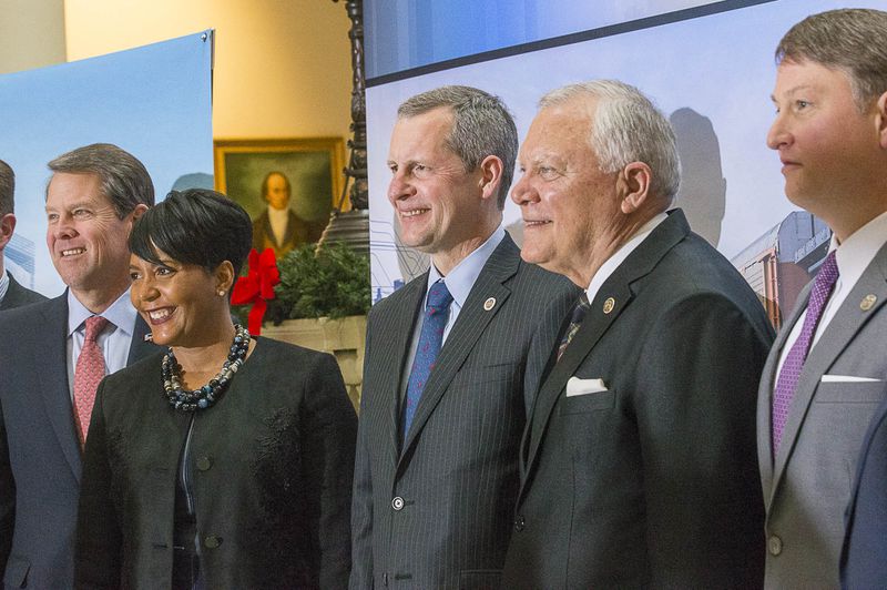 12/12/2018 -- Atlanta, Georgia -- Georgia Governor-Elect Brian Kemp (from left), Atlanta Mayor Keisha Lance Bottoms, Norfolk Southern CEO Jim Squires, Georgia Governor Nathan Deal and Commissioner of the Georgia Department of Economic Development Pat Wilson (right) stand for a photo following a press conference in the Georgia State Capitol building in Atlanta, Wednesday, December 12, 2018. During the presser, Fortune 500 company Norfolk Southern officially announced that they will be moving their headquarters to Atlanta. They will be building in Atlanta's Midtown community. (ALYSSA POINTER/ALYSSA.POINTER@AJC.COM)