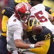 Indiana's Tayven Jackson (2) fumbles the ball in the second half while being hit by Michigan's Michael Barrett (23) at Michigan Stadium on Saturday, Oct. 14, 2023, in Ann Arbor, Michigan. (Gregory Shamus/Getty Images/TNS)