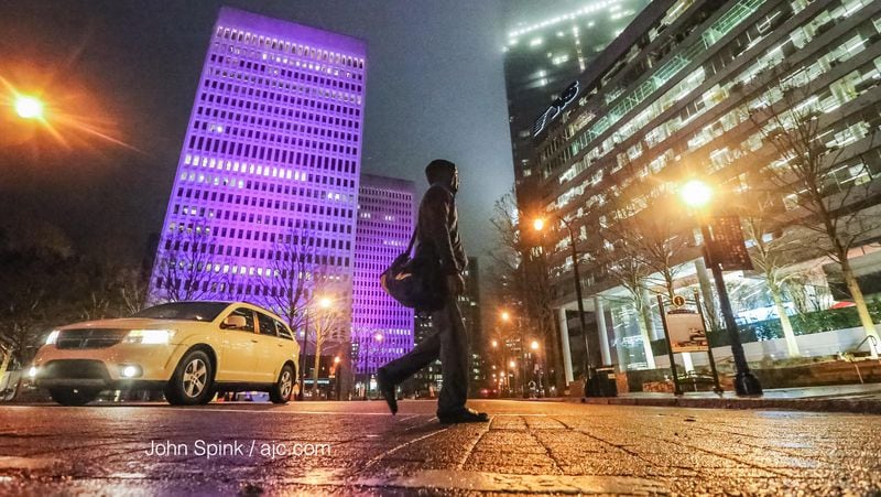 There were reports of drizzle and fog early Thursday in the area of 15th Street in Midtown. JOHN SPINK / JSPINK@AJC.COM