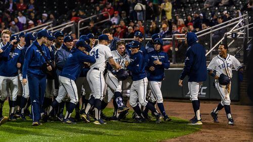 Georgia Tech shortstop Luke Waddell (holding helmet in hand) is mobbed by teammates after his fifth-inning home run against Georgia in the Yellow Jackets' 11-2 win over the Bulldogs March 26, 2019 at Russ Chandler Stadium. (Danny Karnik/Georgia Tech Athletics)