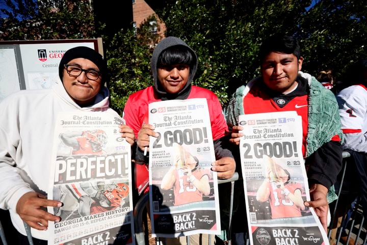 UGA fans Luis Huerta, Jesus Uribe, and Jairo Huerta,  who came from Valdosta, await for the team to arrive at the Dawg Walk during the victory parade in Athens on Saturday, January 14, 2023. Miguel Martinez / miguel.martinezjimenez@ajc.com